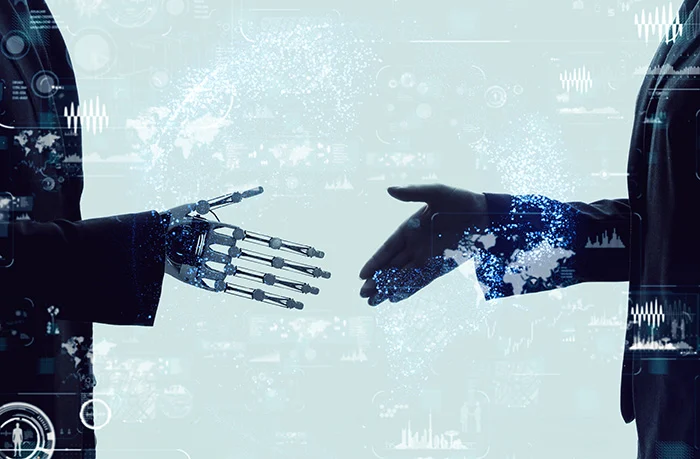 Shaking hands of a businessperson and a robot.