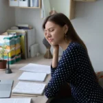 Sad young lady student feeling bored learning dull subject