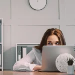 Hiding freelancer laptop hiding lazy woman scared