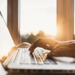 Male hands typing on computer keyboard closeup, business man or student using laptop at home, online learning, internet marketing, working from home, office workplace, freelance concept