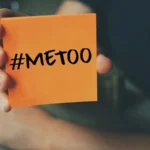Me Too hashtag on orange note paper , anti sexual harassment social media campaign