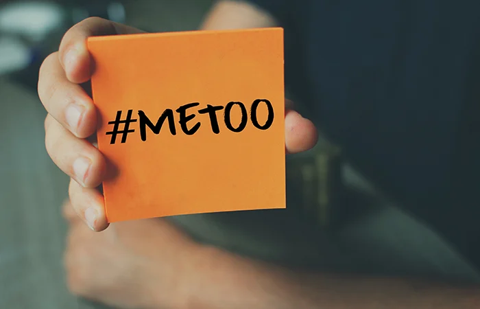 Me Too hashtag on orange note paper , anti sexual harassment social media campaign