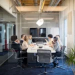 Business people having board meeting in modern office