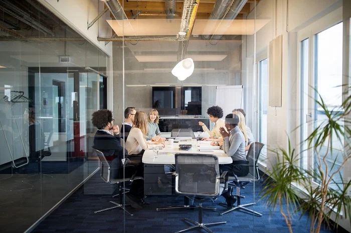 Business people having board meeting in modern office