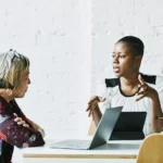 Female financial advisor in discussion with client in office conference room
