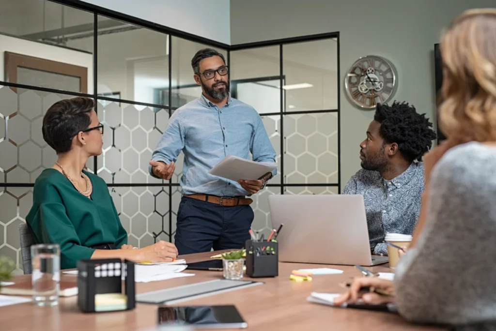 Confident mature businessman giving a presentation to his team i