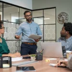 Confident mature businessman giving a presentation to his team i