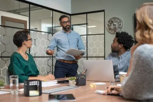 Confident mature businessman giving a presentation to his team i