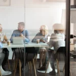Business people negotiating at boardroom behind closed doors