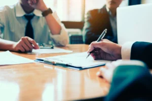 Boardroom with human resource business people writing on paper w
