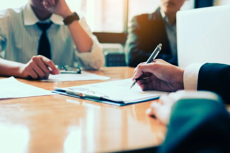 Boardroom with human resource business people writing on paper w