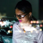 woman engineer looking at various information in screen of futuristic interface.