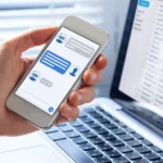 Chatbot conversation on smartphone screen app interface with artificial intelligence technology providing virtual assistant customer support and information, person hand holding mobile phone