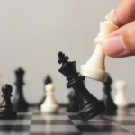 Plan leading strategy of successful business competition leader concept, Hand of player chess board game putting white pawn, Copy space for your text