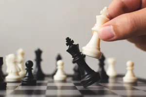 Plan leading strategy of successful business competition leader concept, Hand of player chess board game putting white pawn, Copy space for your text