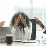 Depressed black woman leader suffering from gender discrimination at work