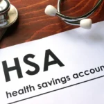 Paper with words  health savings account (HSA) on a table.