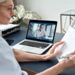 Female hr reading cv during online virtual job interview by video call.