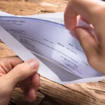 Businessman Opening Envelope With Paycheck