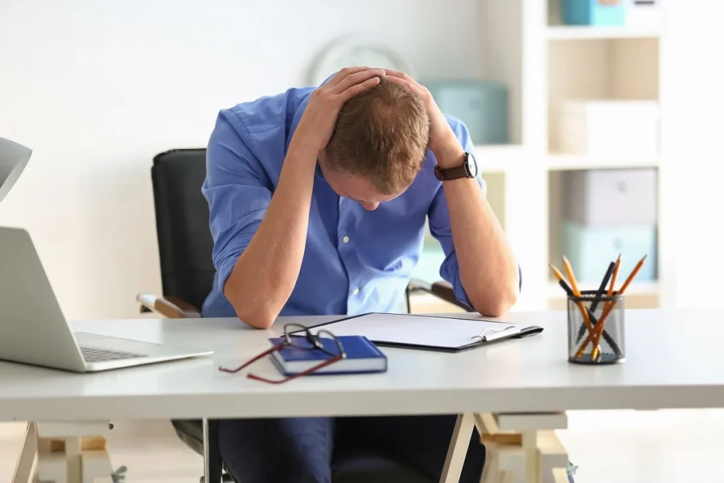 Man having panic attack at workplace in office