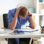 Man having panic attack at workplace in office