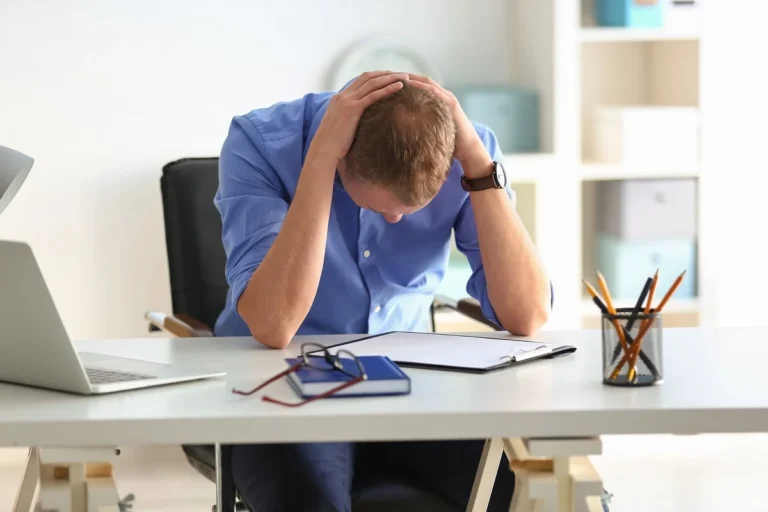 Man having panic attack at workplace in office