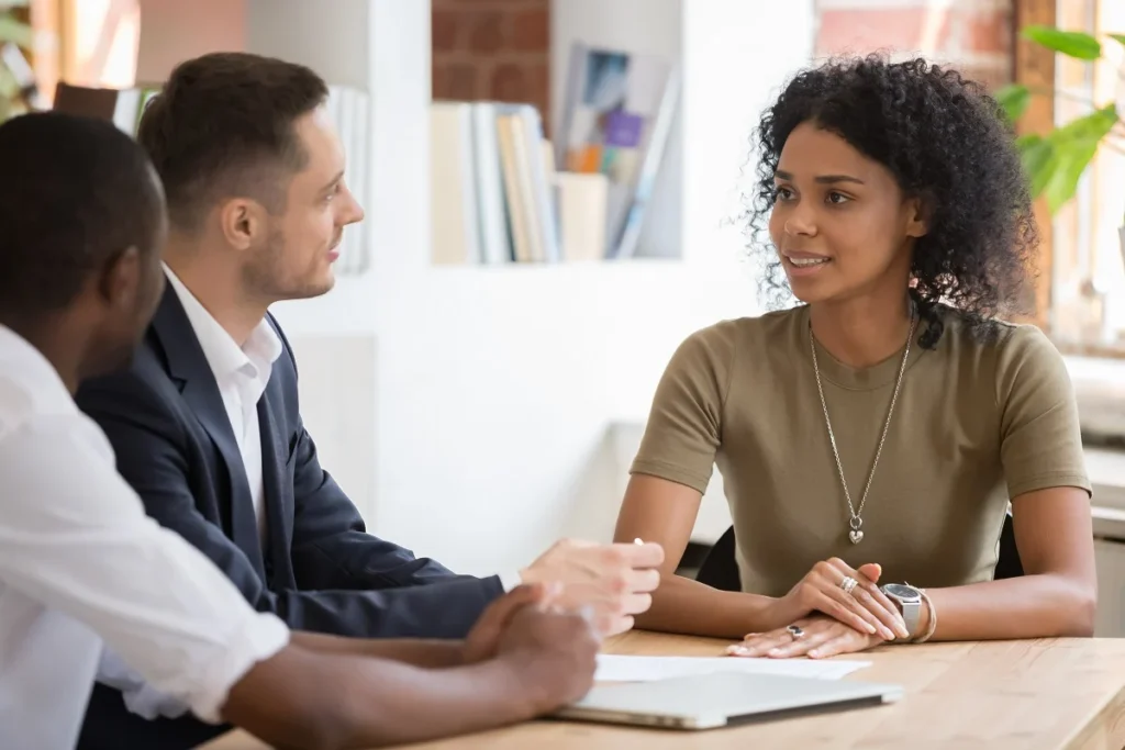 Confident african female applicant talking to diverse hr managers