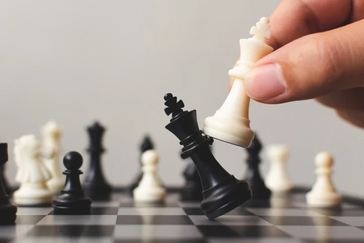 Plan leading strategy of successful business competition leader concept, Hand of player chess board game putting white pawn, Copy space for your text
