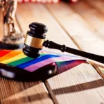 Judge wooden mallet - symbol of law and justice with lgbt rainbow colours flag